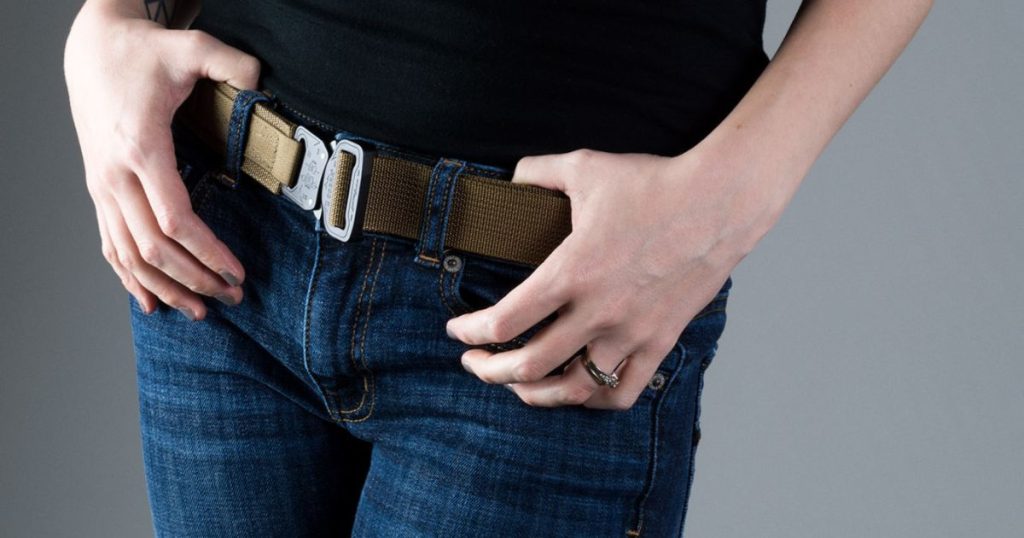 A woman in jeans and a black shirt wearing a Blue Alpha EDC Belt for a casual day look.