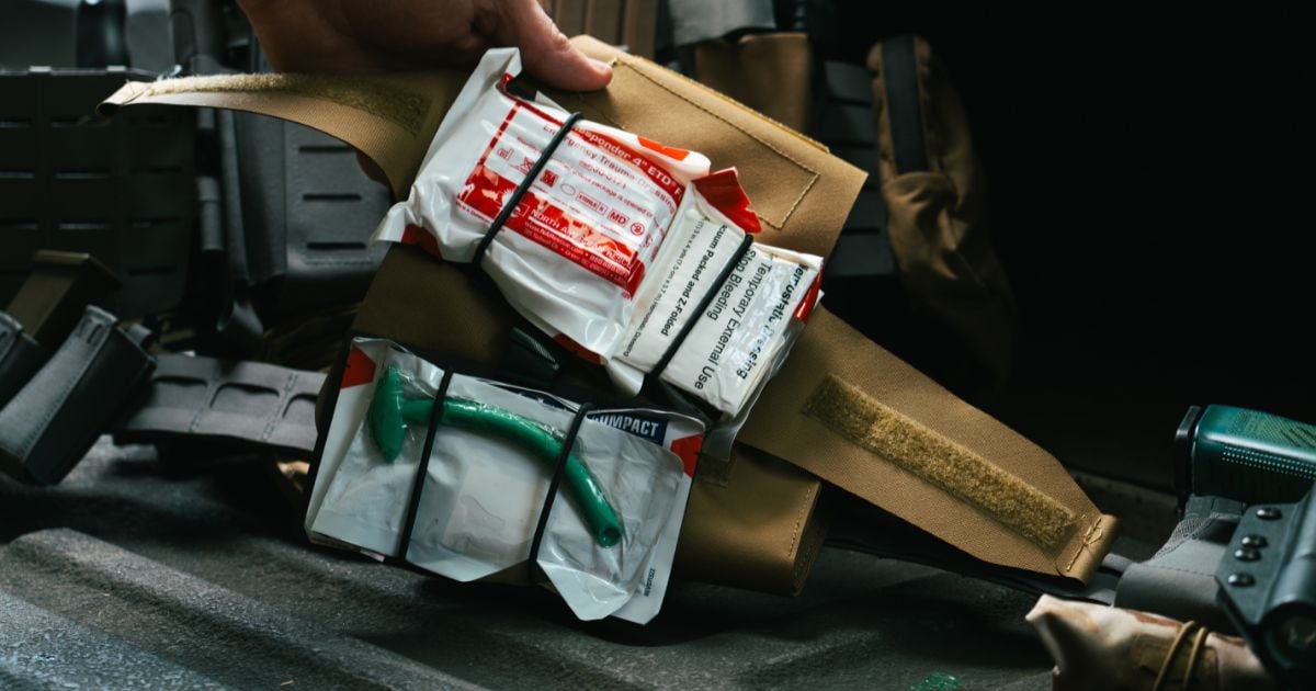 A Blue Alpha Medical Pouch open showing the medical supplies inside.
