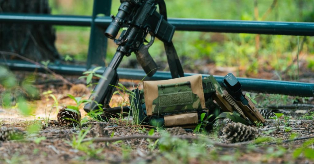 A Blue Alpha Battle Belt with a Medical Pouch connected laying on the ground.