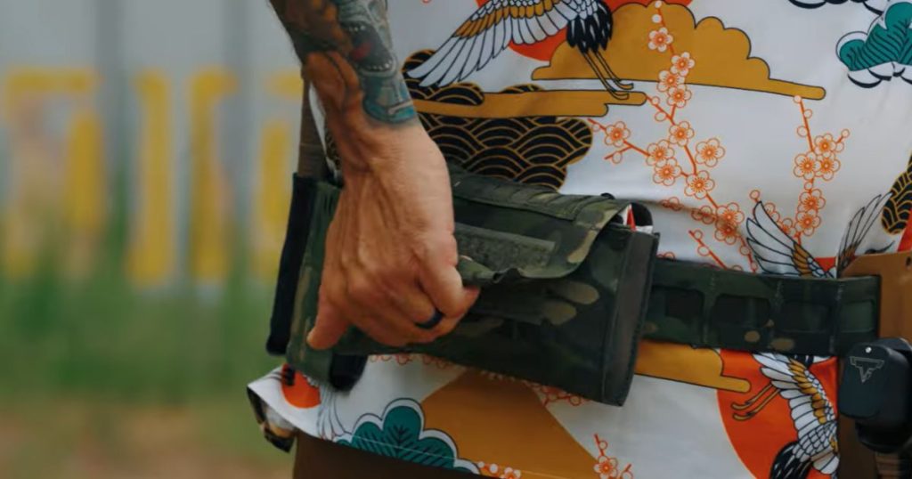 A man using a top pull setup for his medical pouch from Blue Alpha.