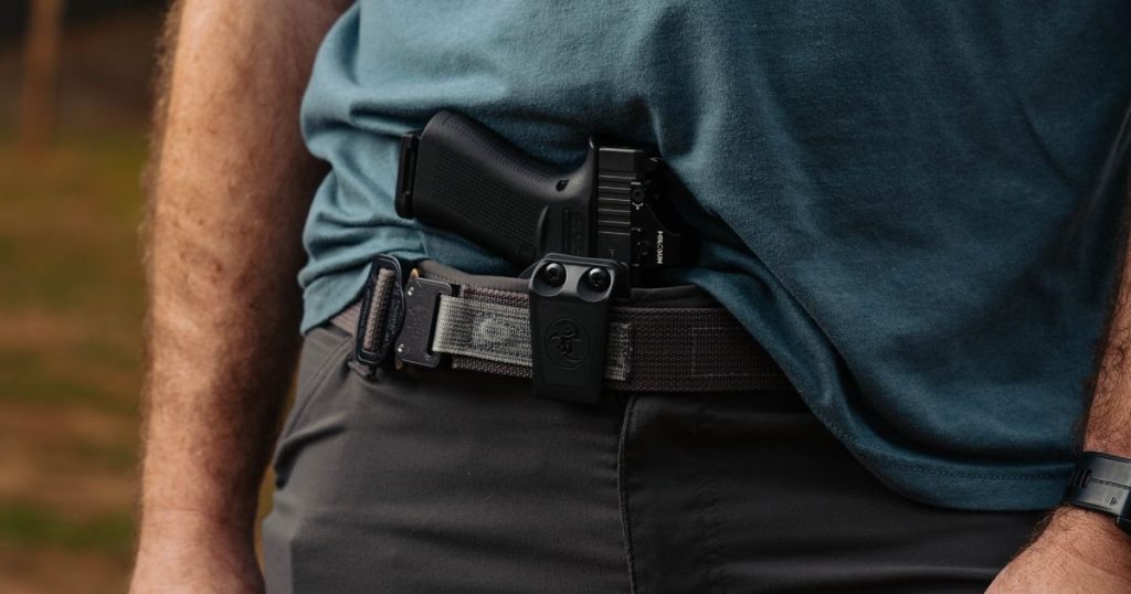 A man wearing the Blue Alpha EDC belt while working.