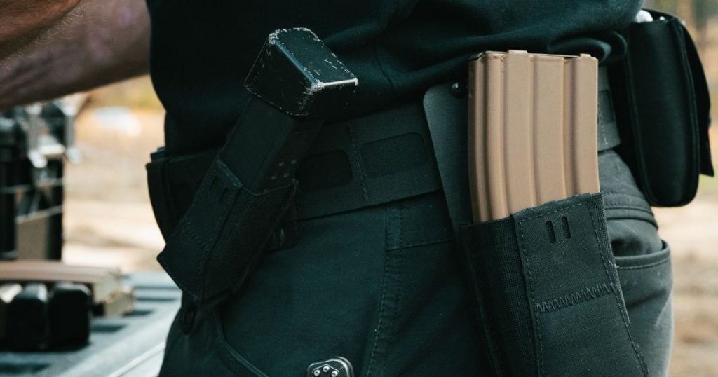 A man wearing a Blue Alpha Battle Belt with several spare mags.