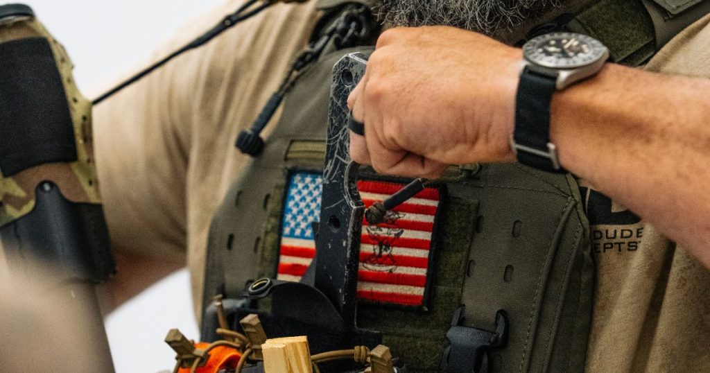 A man pulling his BRB out of his pouch attached to his chest rig.