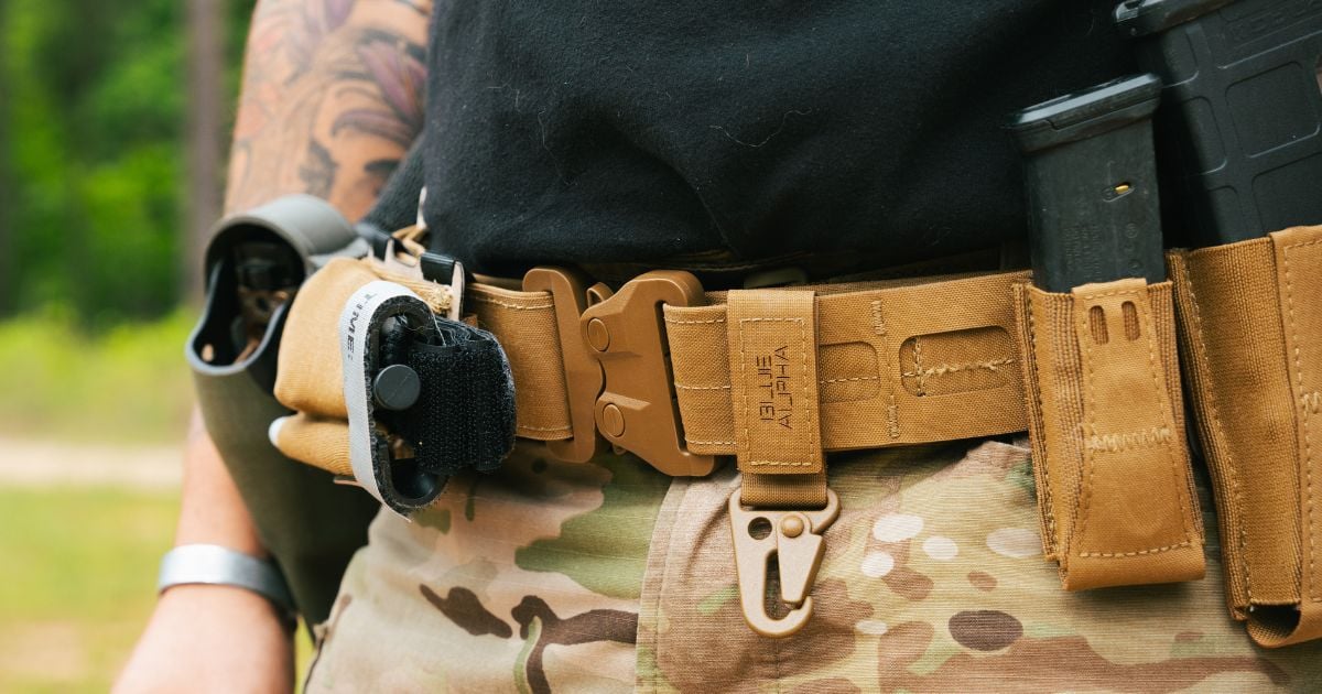 A man wearing a Blue Alpha Battle Belt with various pouches.