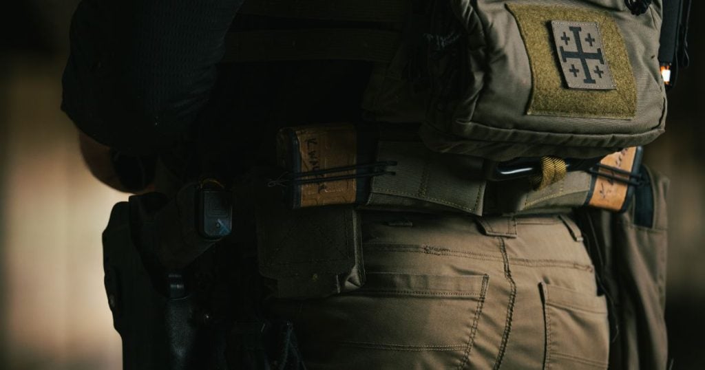 A man using the Blue Alpha +2 to increase his carrying capacity on his plate carrier.